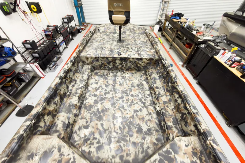 Slide: The Image of Camouflage-patterned Excel Eclipse 2026 boat interior in a workshop setting. - 21