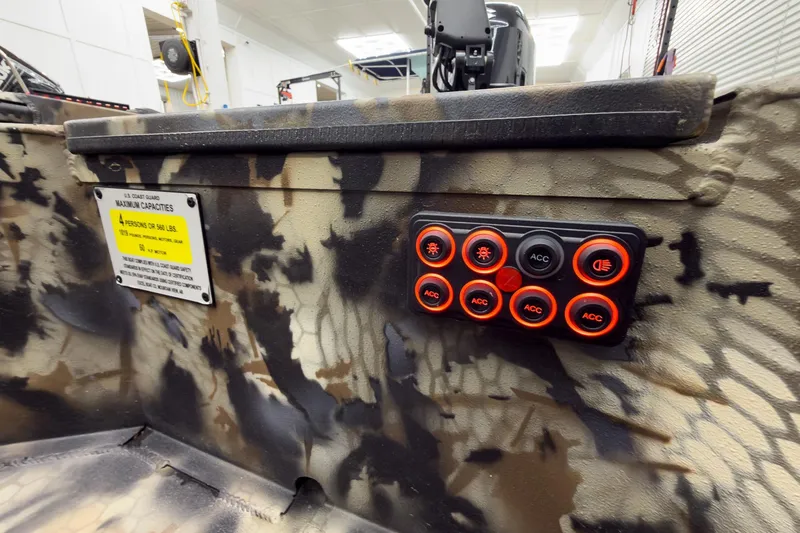 Slide: The Image of Control panel on camouflaged Excel Eclipse 2026 boat with capacity sign. - 23