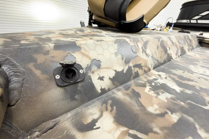 Slide: The Image of Camouflage-patterned Excel Eclipse 2026 boat interior with mounted seat and accessory port. - 24