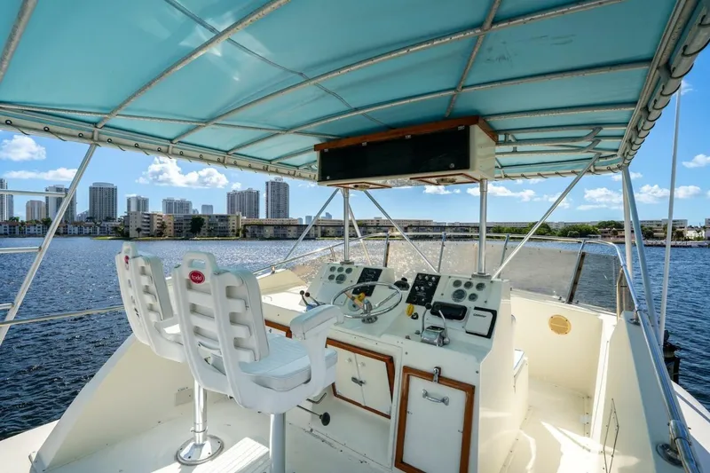 Slide: The Image of 1978 Hatteras 53 Yacht Fisherman helm with city skyline and water view. - 24