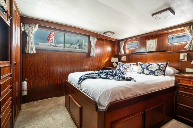 Slide: The Image of Luxurious cabin interior of 1978 Hatteras 53 Yacht Fisherman with wood paneling and cozy bedding. - 38