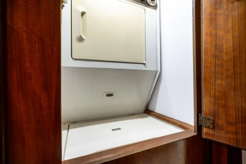 Slide: The Image of Laundry area inside 1978 Hatteras 53 Yacht Fisherman, featuring wooden cabinetry. - 39
