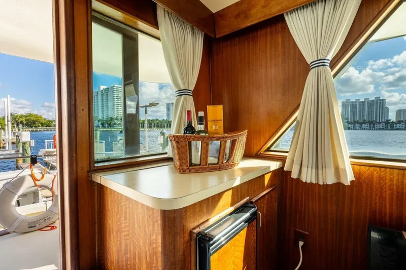 Slide: The Image of Interior of 1978 Hatteras 53 Yacht Fisherman with waterfront view and wine basket. - 48