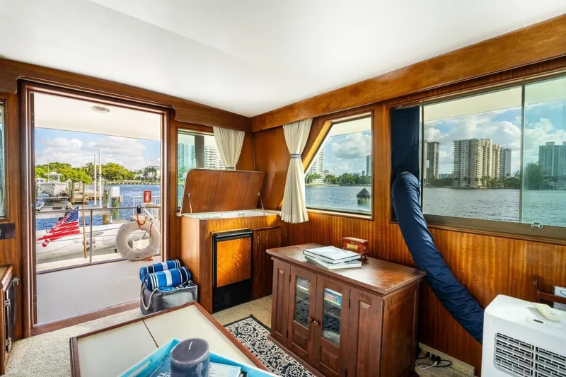 Slide: The Image of Interior of 1978 Hatteras 53 Yacht Fisherman with wood paneling and waterfront view. - 51