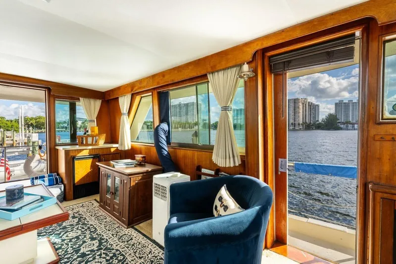 Slide: The Image of Interior of a 1978 Hatteras 53 Yacht Fisherman with elegant wood paneling and waterfront view. - 54