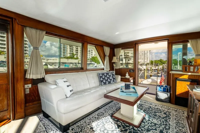 Slide: The Image of Luxurious interior of 1978 Hatteras 53 Yacht Fisherman with elegant furnishings and marina view. - 55