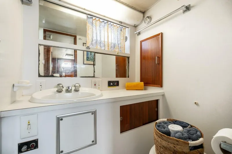 Slide: The Image of Bathroom interior of 1978 Hatteras 53 Yacht Fisherman with sink, mirror, and storage. - 57