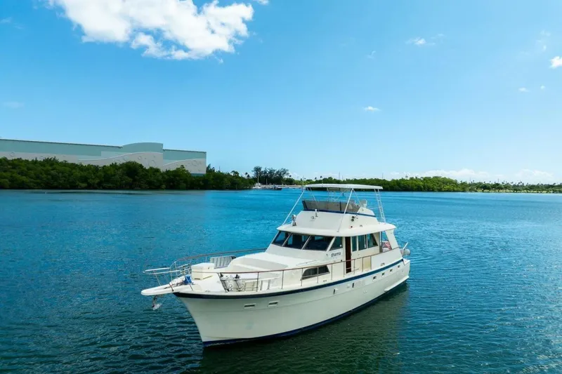 Slide: The Image of 1978 Hatteras 53 Yacht Fisherman on serene blue water under clear sky. - 6