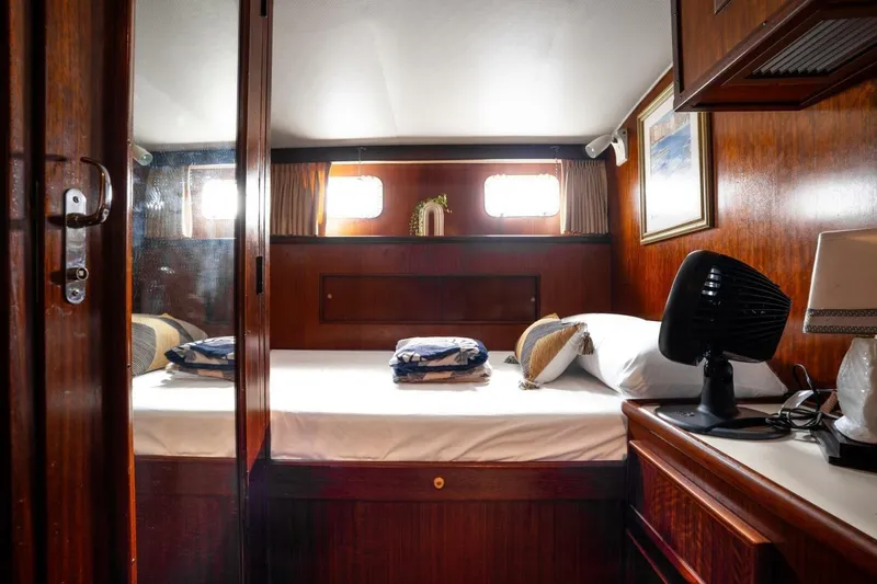 Slide: The Image of Cozy cabin interior of 1978 Hatteras 53 Yacht Fisherman with wooden decor and comfortable bedding. - 69
