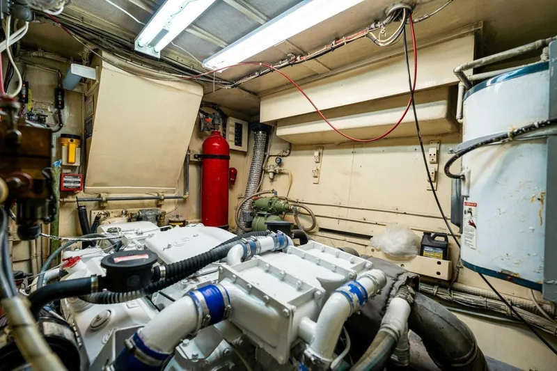 Slide: The Image of Engine room of a 1978 Hatteras 53 Yacht Fisherman with visible machinery and equipment. - 77