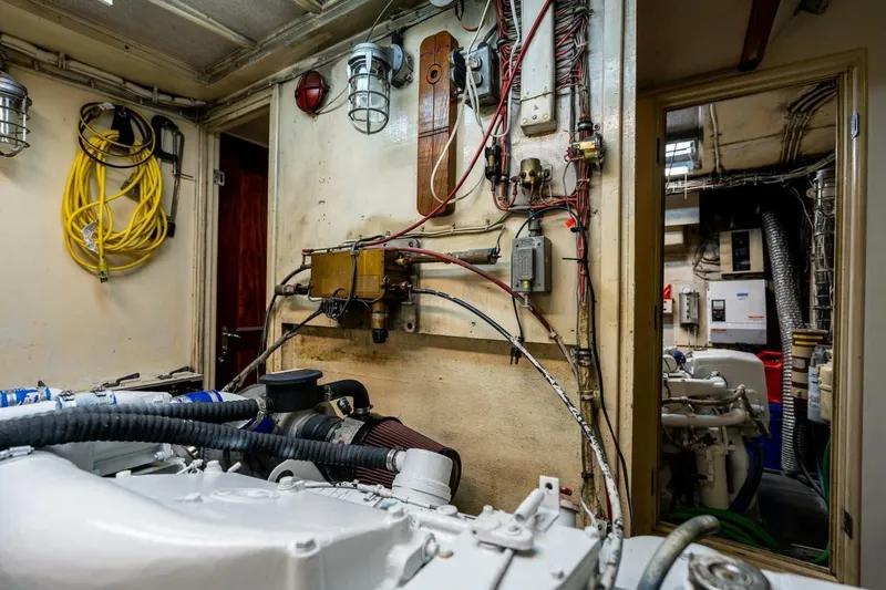 Slide: The Image of Engine room of a 1978 Hatteras 53 Yacht Fisherman with visible wiring and machinery. - 80