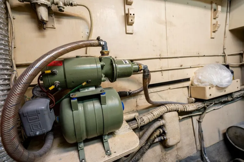 Slide: The Image of Engine room of 1978 Hatteras 53 Yacht Fisherman with mechanical equipment and piping. - 82