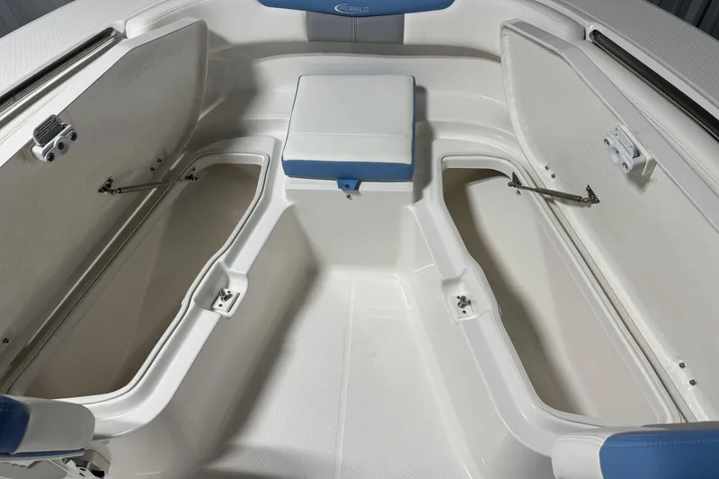 Slide: The Image of 2026 Robalo R202 Explorer boat interior with open storage compartments and seating. - 4