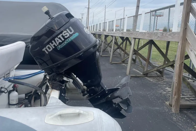 Slide: The Image of Tohatsu FourStroke engine on 2014 Walker Bay Odyssey 325 ST Console boat. - 2