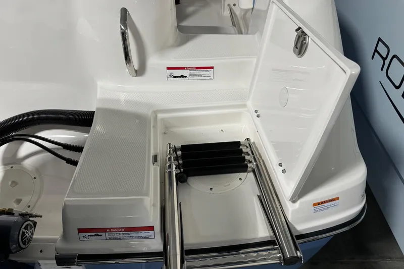 Slide: The Image of 2026 Robalo R202 Explorer boat with open swim platform ladder compartment. - 13