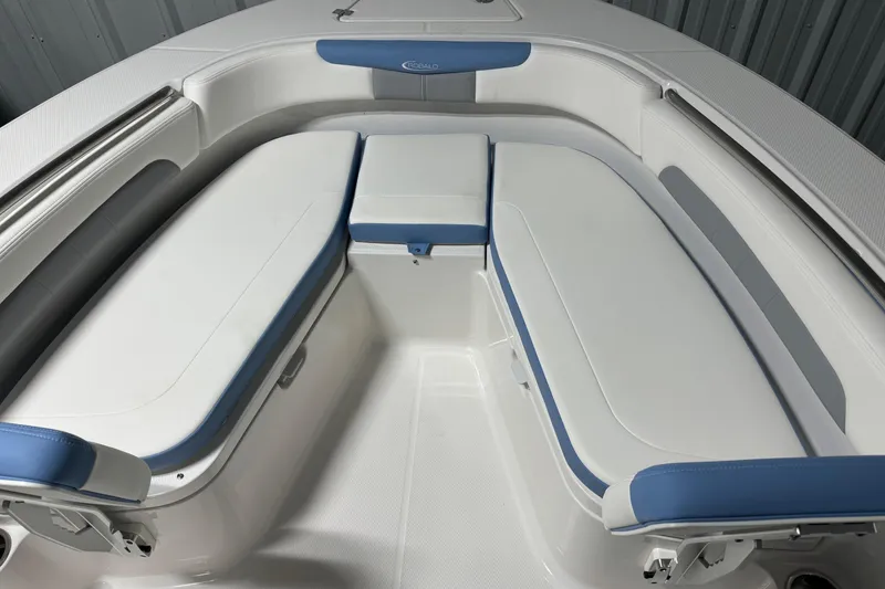 Slide: The Image of 2026 Robalo R202 Explorer boat interior with white and blue cushioned seating. - 16