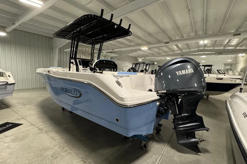 Slide: The Image of 2026 Robalo R202 Explorer boat with Yamaha engine in showroom. - 3