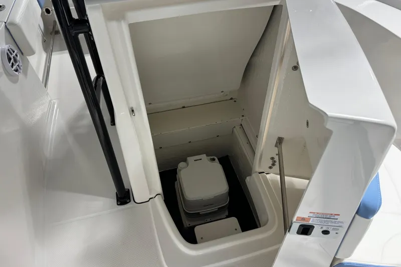 Slide: The Image of 2026 Robalo R202 Explorer boat storage compartment with portable toilet. - 6