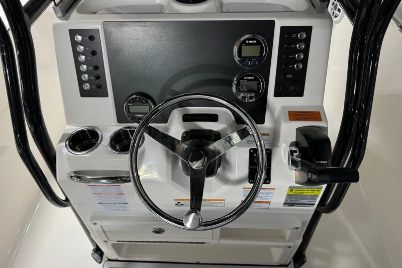 Slide: The Image of 2026 Robalo R202 Explorer boat dashboard with steering wheel and control panel. - 9