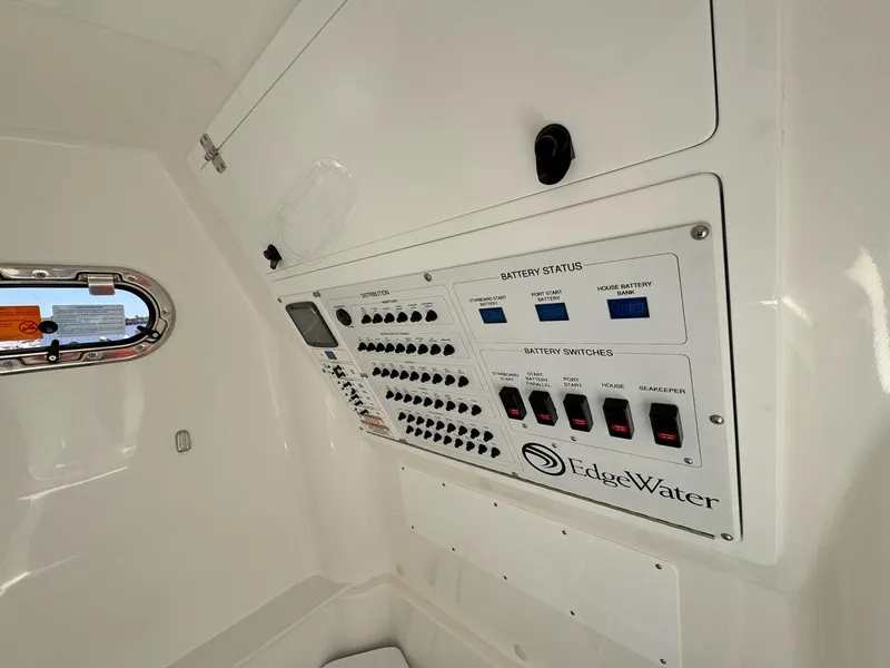 Slide: The Image of Control panel of 2025 Edgewater 340CC boat, featuring battery status and switches. - 15