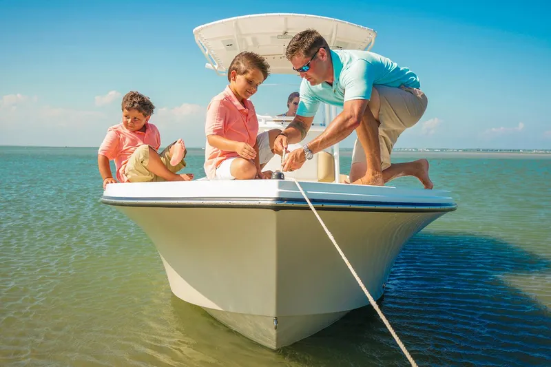 Slide: The Image of 2018 Parker 2300 Special Edition boat with Yamaha 200 engine in marina setting. - 2