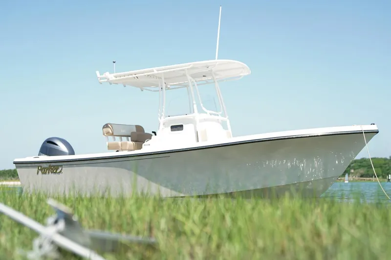 Slide: The Image of 2018 Parker 2300 Special Edition boat interior with modern controls, docked at a marina. - 3