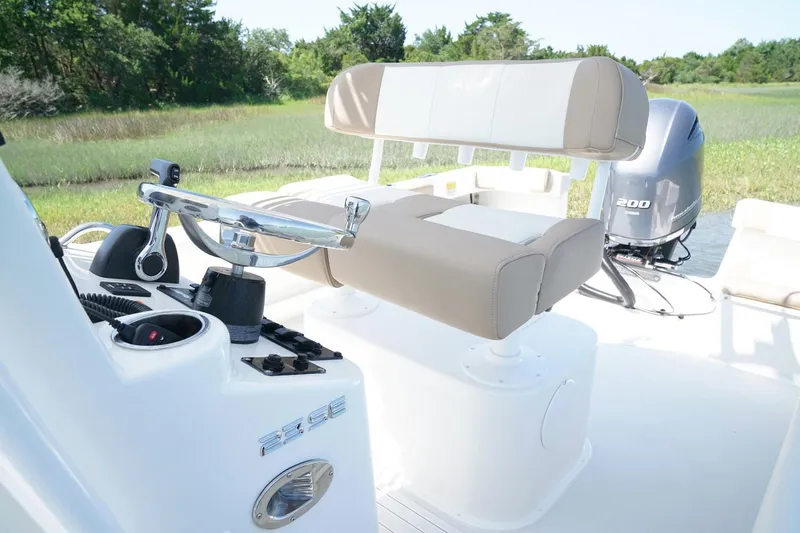 Slide: The Image of Control panel of a 2018 Parker 2300 Special Edition boat with steering wheel and navigation equipment. - 7