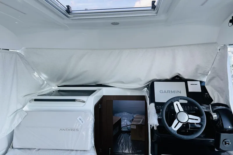Slide: The Image of Interior of 2026 Beneteau Antares 9 V2 with Garmin navigation system and steering wheel. - 11