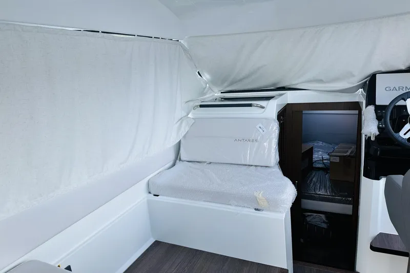 Slide: The Image of Interior of 2026 Beneteau Antares 9 V2 boat, featuring helm and cabin area. - 12