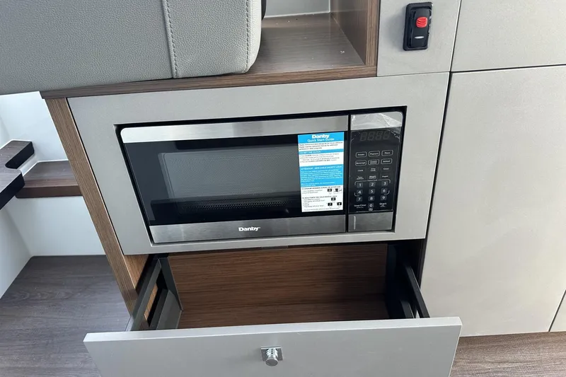 Slide: The Image of 2026 Beneteau Antares 9 V2 interior with Danby microwave and storage drawer. - 20