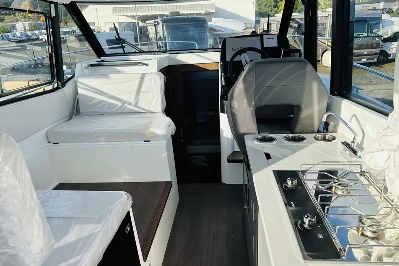 Slide: The Image of Interior of 2026 Beneteau Antares 9 V2 boat with modern seating and kitchen area. - 21