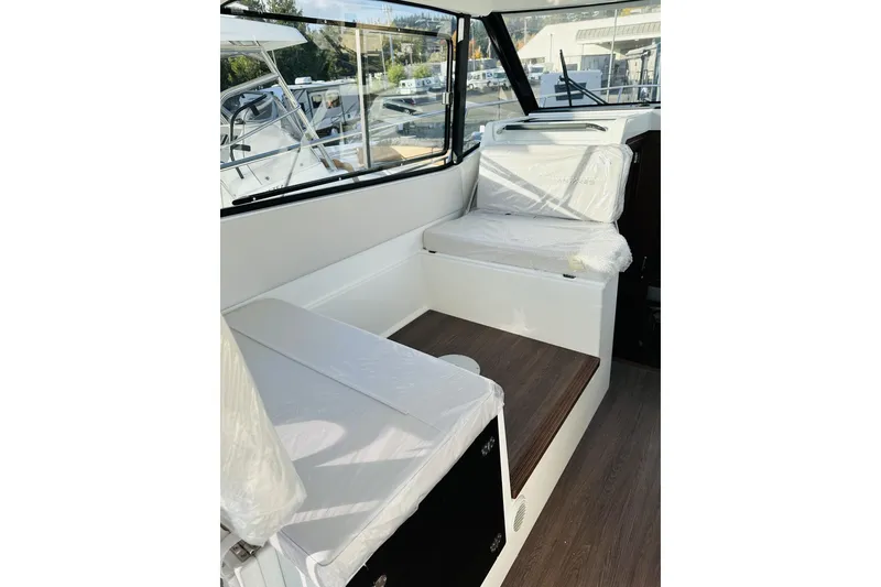 Slide: The Image of Interior of 2026 Beneteau Antares 9 V2 boat, featuring seating and windows. - 22