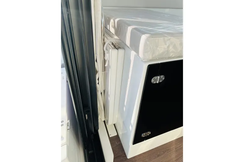 Slide: The Image of Interior view of 2026 Beneteau Antares 9 V2, featuring a compact storage area. - 23