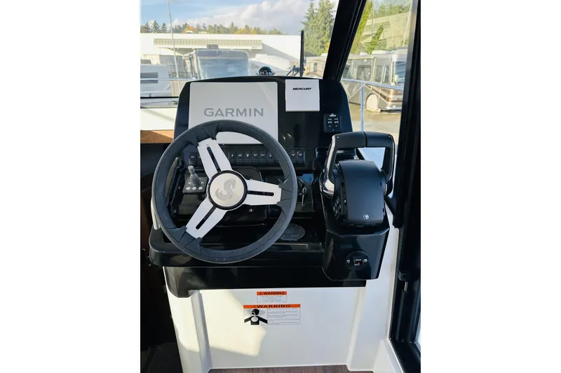 Slide: The Image of 2026 Beneteau Antares 9 V2 helm with Garmin navigation and Mercury controls. - 25