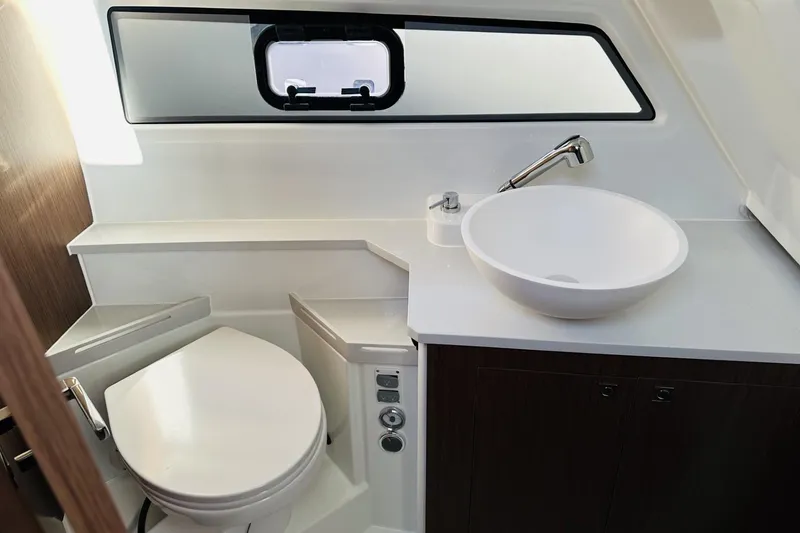 Slide: The Image of Modern bathroom in 2026 Beneteau Antares 9 V2 boat, featuring sleek sink and toilet. - 27