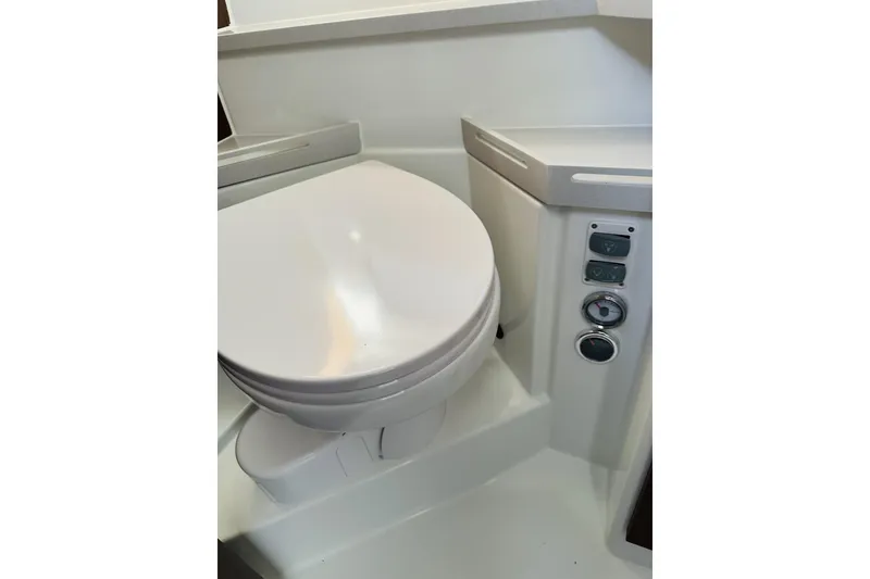Slide: The Image of 2026 Beneteau Antares 9 V2 boat bathroom with modern toilet and control panel. - 28