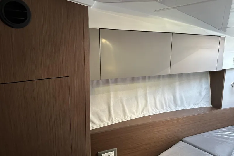 Slide: The Image of Interior of 2026 Beneteau Antares 9 V2, featuring sleek wood cabinetry and modern design. - 29