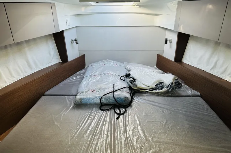 Slide: The Image of Interior cabin of 2026 Beneteau Antares 9 V2, featuring a neatly arranged bed. - 30