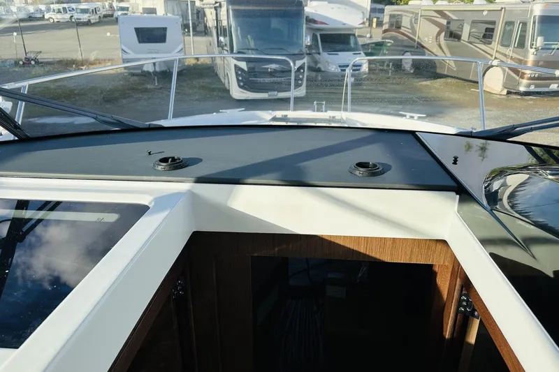 Slide: The Image of 2026 Beneteau Antares 9 V2 helm view with RVs in the background. - 33
