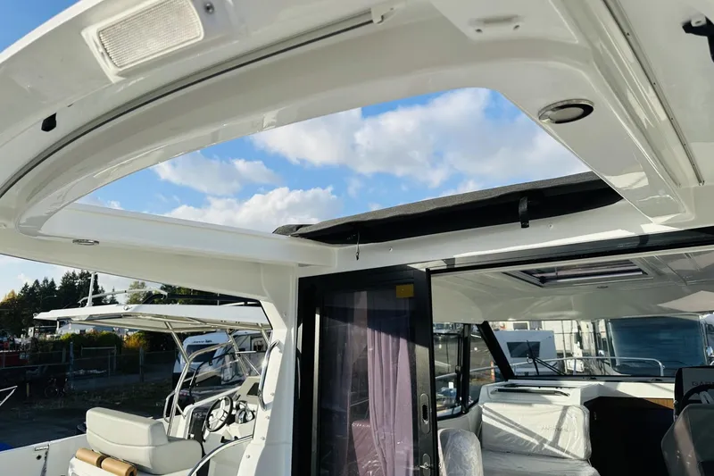 Slide: The Image of 2026 Beneteau Antares 9 V2 boat interior with open sunroof and modern design. - 5