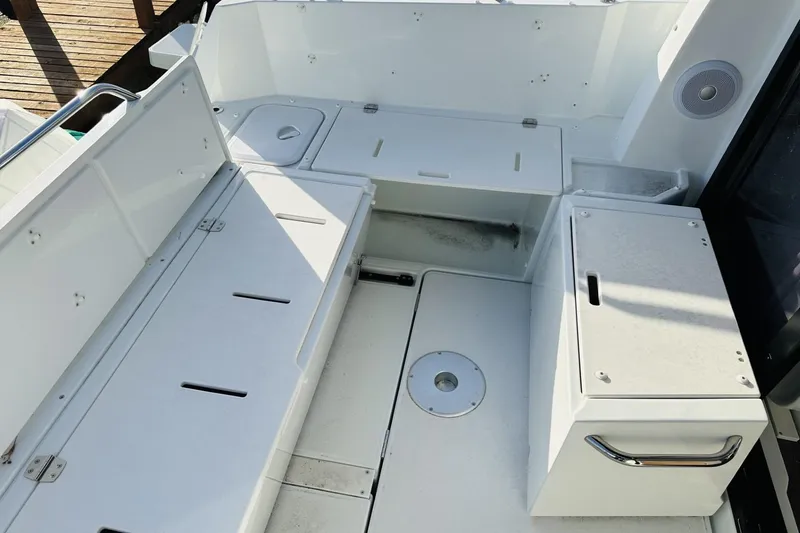 Slide: The Image of 2026 Beneteau Antares 9 V2 boat deck with seating and storage compartments. - 6