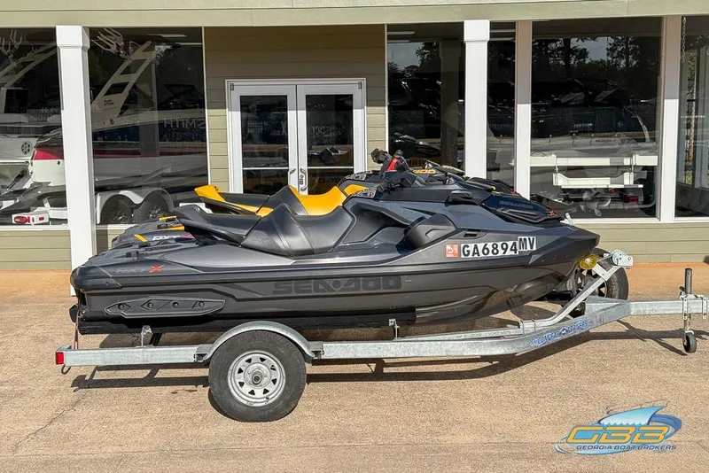 The Image of 2023 Sea-Doo RXT-X 300 jet ski on trailer outside dealership. - 0