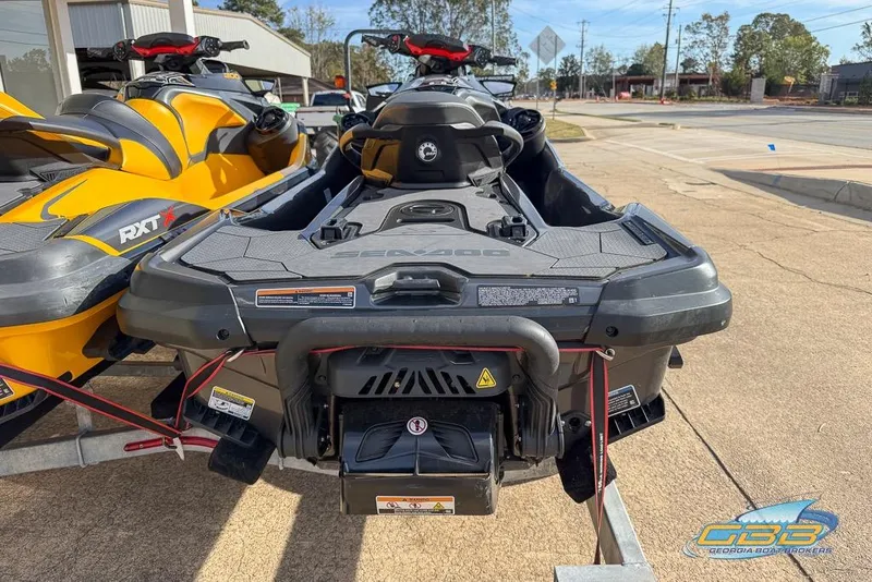 Slide: The Image of 2023 Sea-Doo RXT-X 300 jet ski, yellow and black, parked on a trailer. - 10
