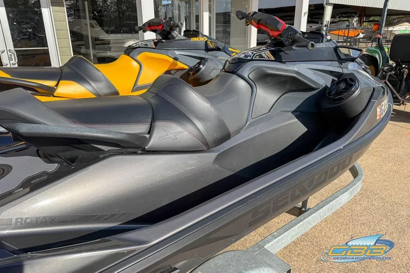 Slide: The Image of 2023 Sea-Doo RXT-X 300 jet ski in showroom, featuring sleek design and comfortable seating. - 3