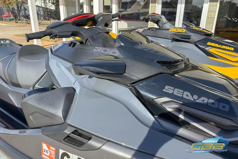 Slide: The Image of 2023 Sea-Doo RXT-X 300 jet ski, sleek design, parked outdoors. - 9
