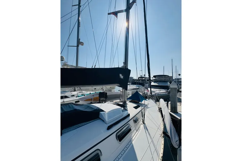 Slide: The Image of 1989 Hunter Legend 37 sailboat docked in a marina under clear blue skies. - 12