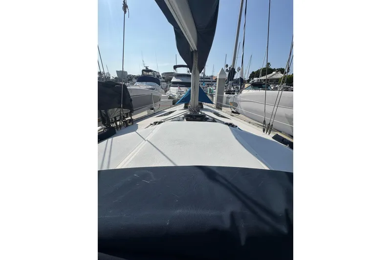 Slide: The Image of 1989 Hunter Legend 37 sailboat docked in a sunny marina, showcasing its sleek design. - 16