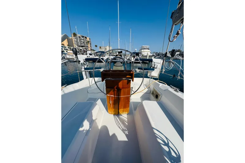 Slide: The Image of 1989 Hunter Legend 37 sailboat docked, featuring sleek design and blue covers. - 17