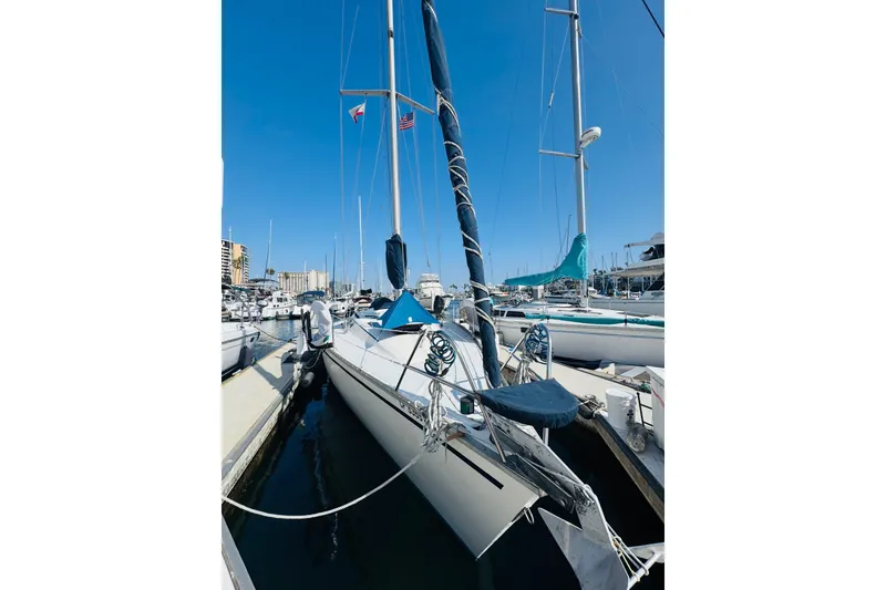 Slide: The Image of Hunter Legend 37 sailboat, 1990 model, named "NAIAD" with a paddleboard on deck. - 2