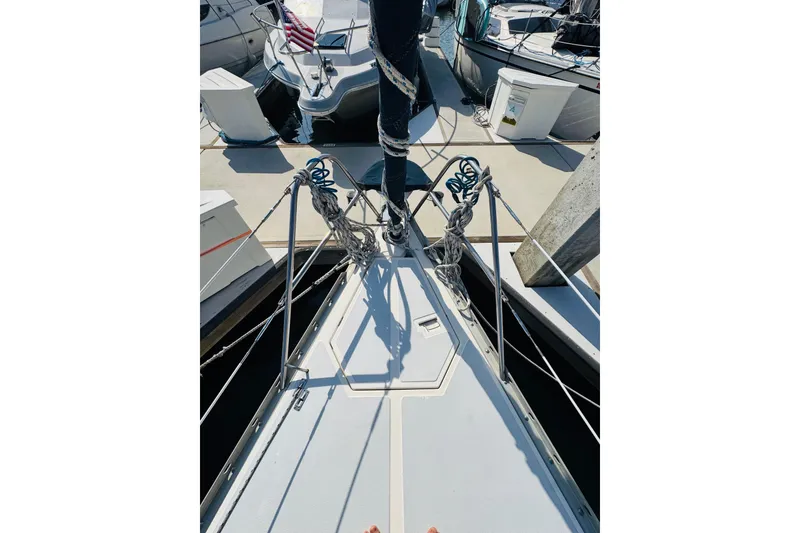 Slide: The Image of Cockpit view of 1989 Hunter Legend 37 sailboat with steering wheel and marina background. - 22